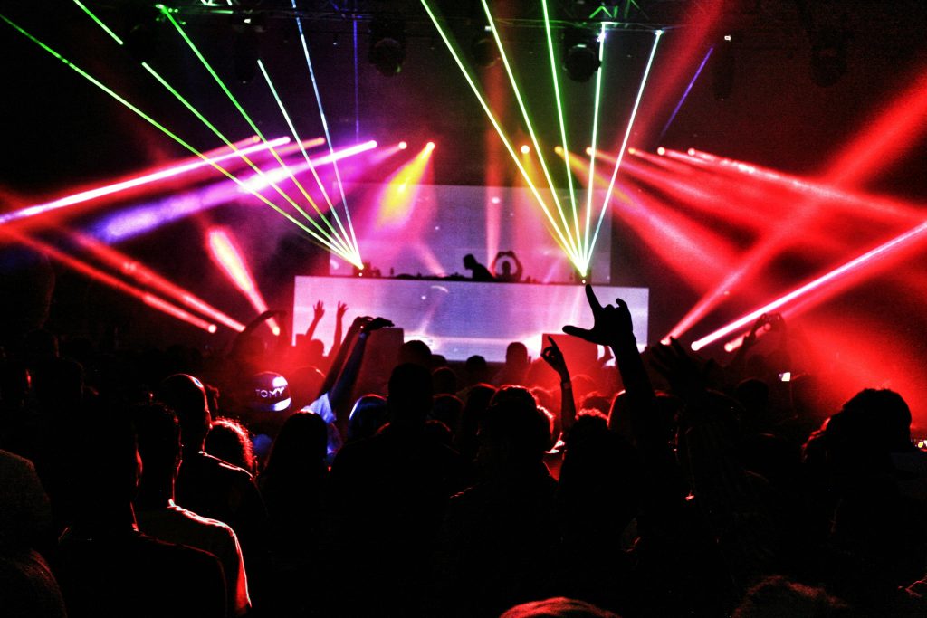 pexels photo 2114365 2114365 Energetic nightclub scene with laser lights and a lively crowd dancing to EDM music.